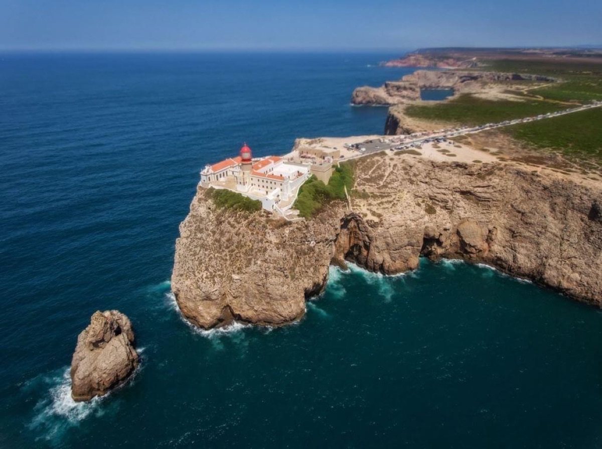 Aerial view of Cape St. Vincent headland with lighthouse at the edge of the Atlantic, Sagres