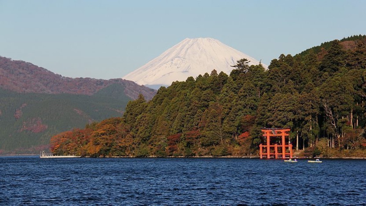Golden pirate ship sailing on Lake Ashi with snow-capped Mount Fuji, Hakone