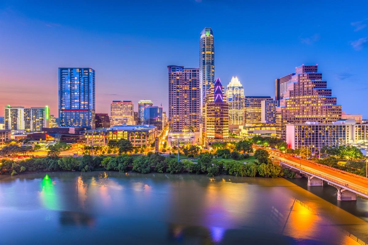 Austin Texas downtown skyline twilight reflection on Lady Bird Lake with Frost Tower lit up
