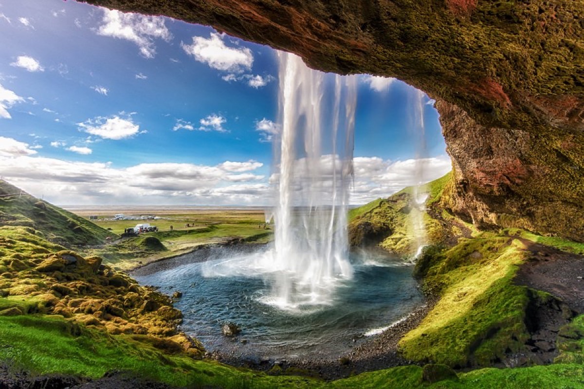 Seljalandsfoss waterfall in Iceland — walk-behind viewpoint with lush green canyon