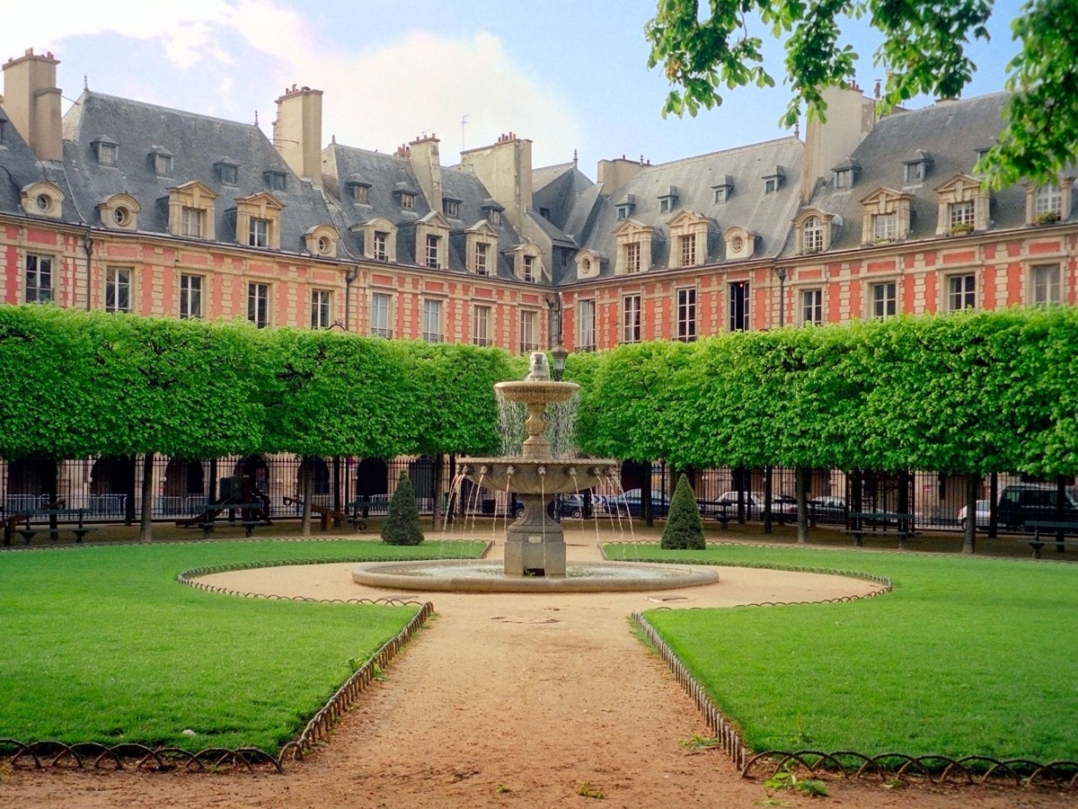 Place des Vosges in Le Marais, Paris – romantic cobblestone square with fountains and red-brick arcades