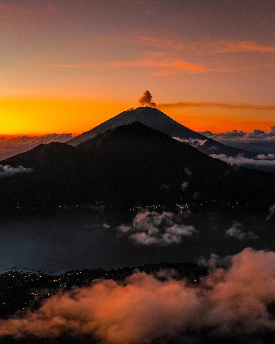 Mount Batur volcano silhouette at sunrise with dramatic dawn sky, Bali