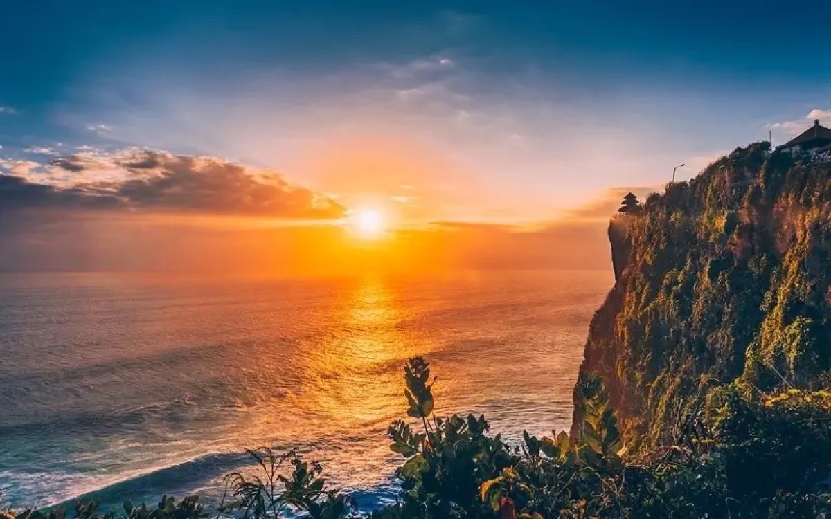 Uluwatu Temple on Bali cliff edge at golden sunset over the ocean