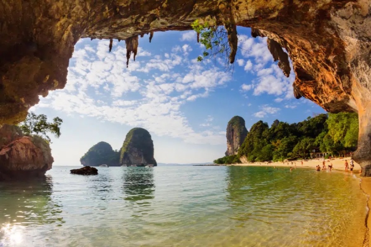 Phra Nang Cave Beach Krabi viewed through cave opening with limestone karsts and crystal water