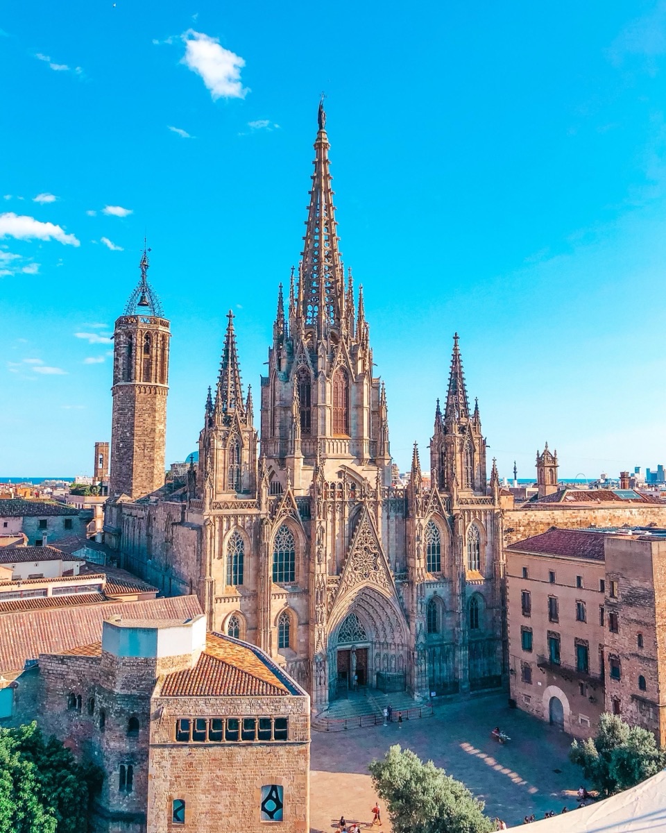 Barcelona Cathedral rising above the Gothic Quarter rooftops at golden hour