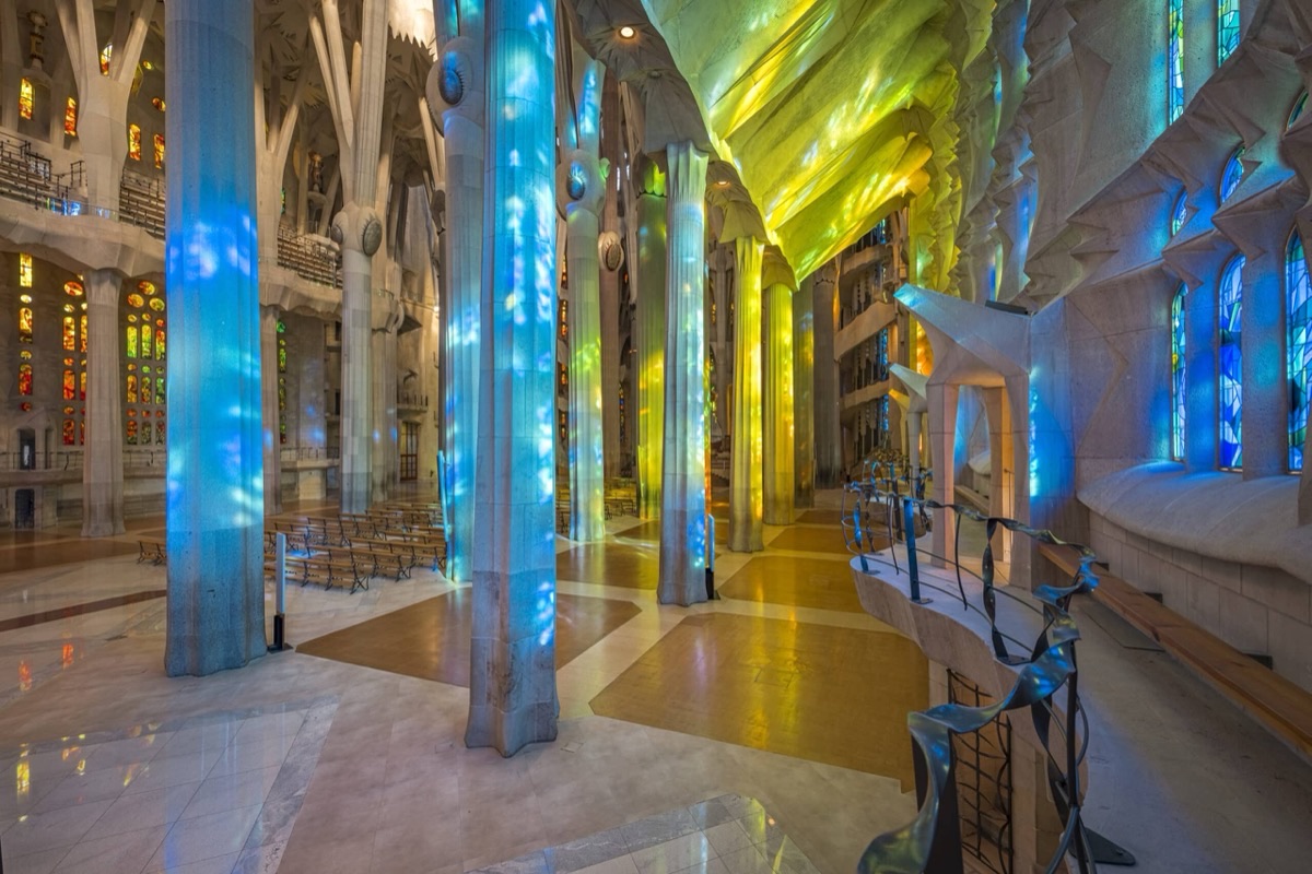 Sagrada Familia interior with kaleidoscope of colored stained glass light on soaring columns