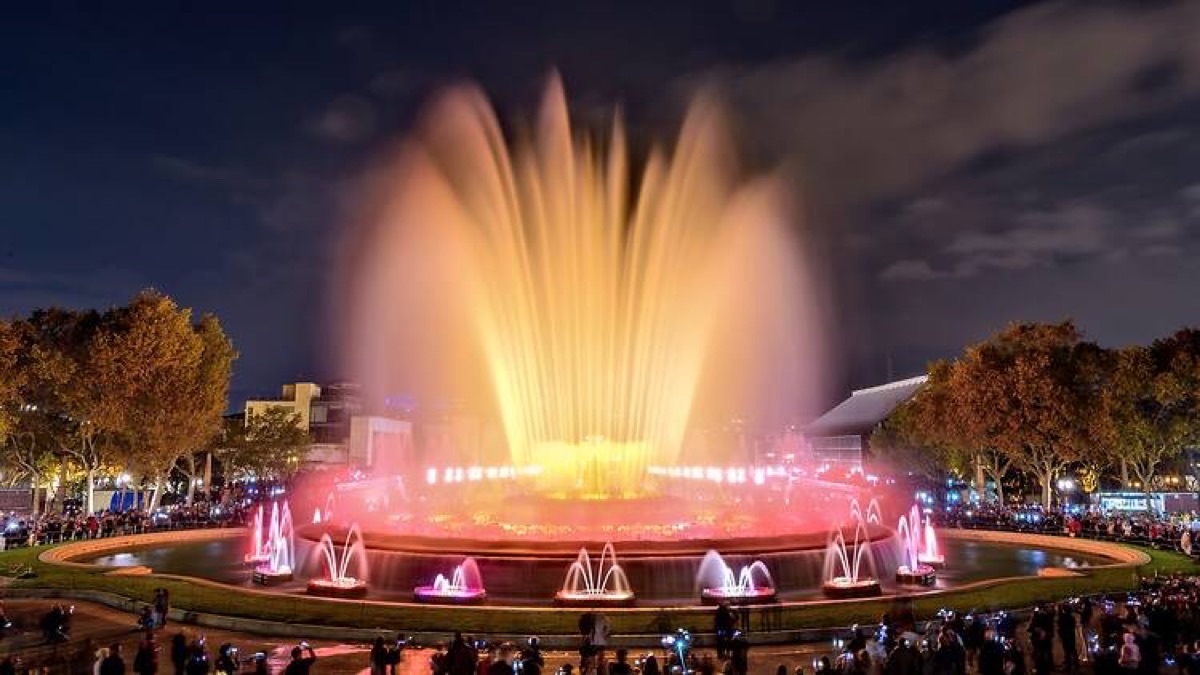 Magic Fountain of Montjuïc at night with golden water jets and dramatic illuminated display