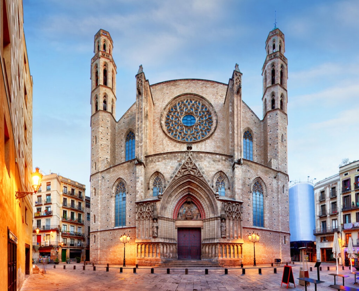 El Born neighborhood with Santa Maria del Mar church and café terrace in golden morning light