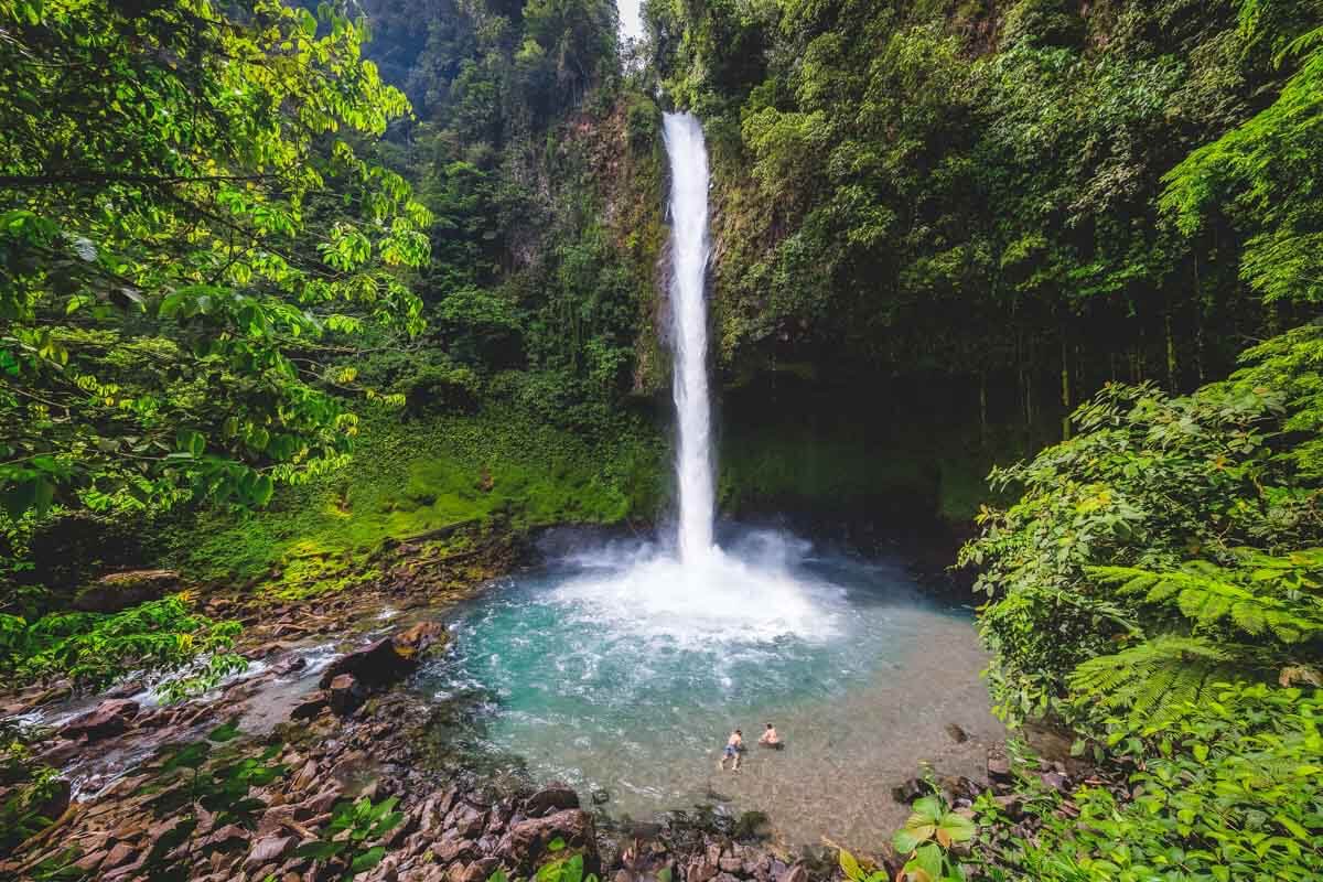 La Fortuna Waterfall cascading into turquoise pool surrounded by lush Costa Rica rainforest