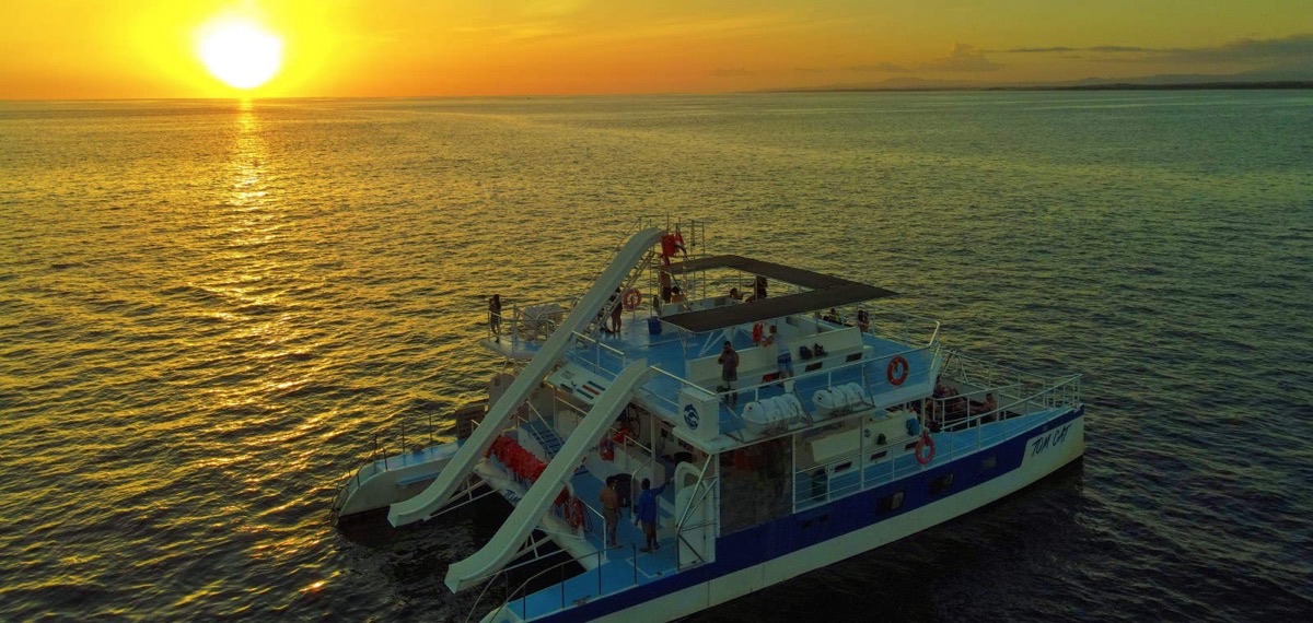 Catamaran sailing into golden sunset on the Pacific Ocean near Manuel Antonio, Costa Rica