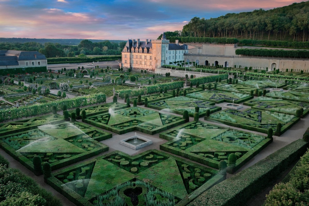 Villandry Gardens ornamental parterres with château at sunset, Loire Valley