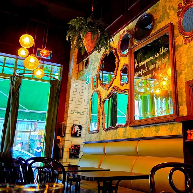 Hey Jupiter French bistro interior with gilded mirrors and warm Parisian ambiance in Adelaide CBD