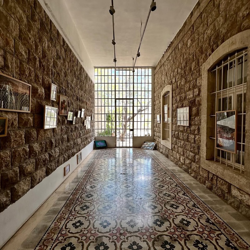 Interior gallery space at MMAG Foundation with traditional tile floors and artwork on display in Jabal Amman