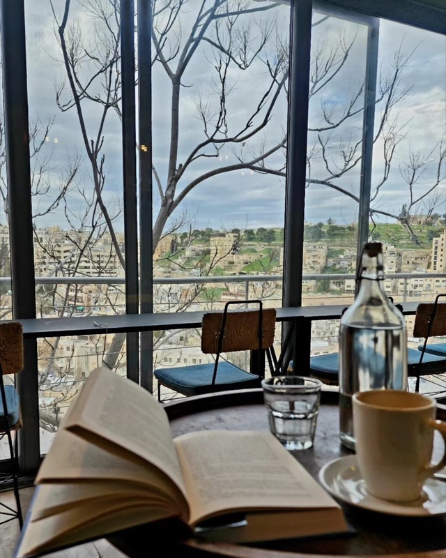 Majnoon Qahwa cafe interior with Amman hillside views in Abdoun, Amman