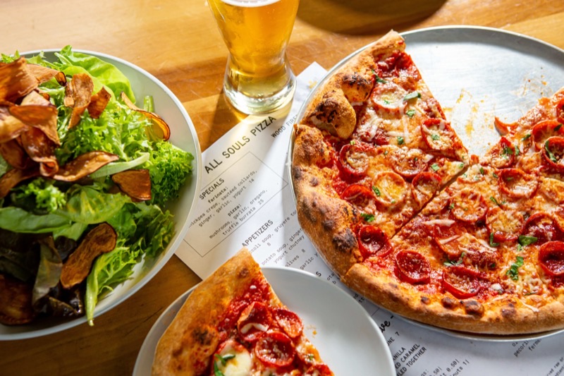 All Souls Pizza in River Arts District (RAD) — All Souls Pizza excels with its perfectly charred, thin-crust wood-fired pizzas,
