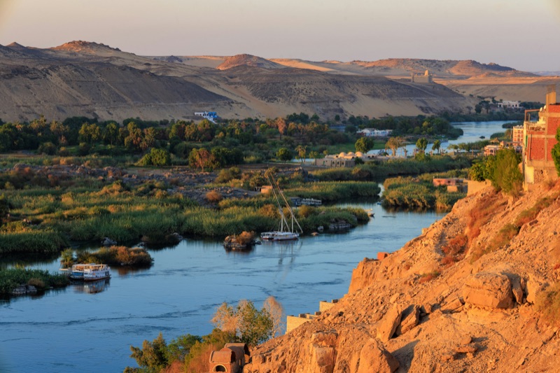 Felucca sailing through rocky granite islands at the First Cataract Aswan
