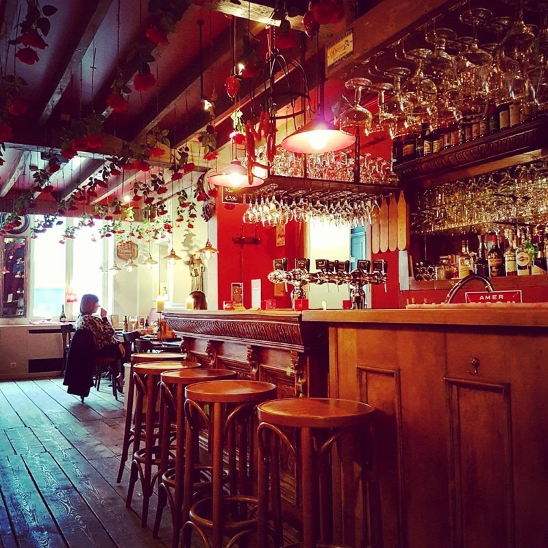 Rose Red cozy cafe bar decorated with hanging roses in Bruges, Belgium