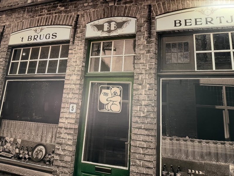 't Brugs Beertje iconic bear mascot and historic facade in Bruges, Belgium