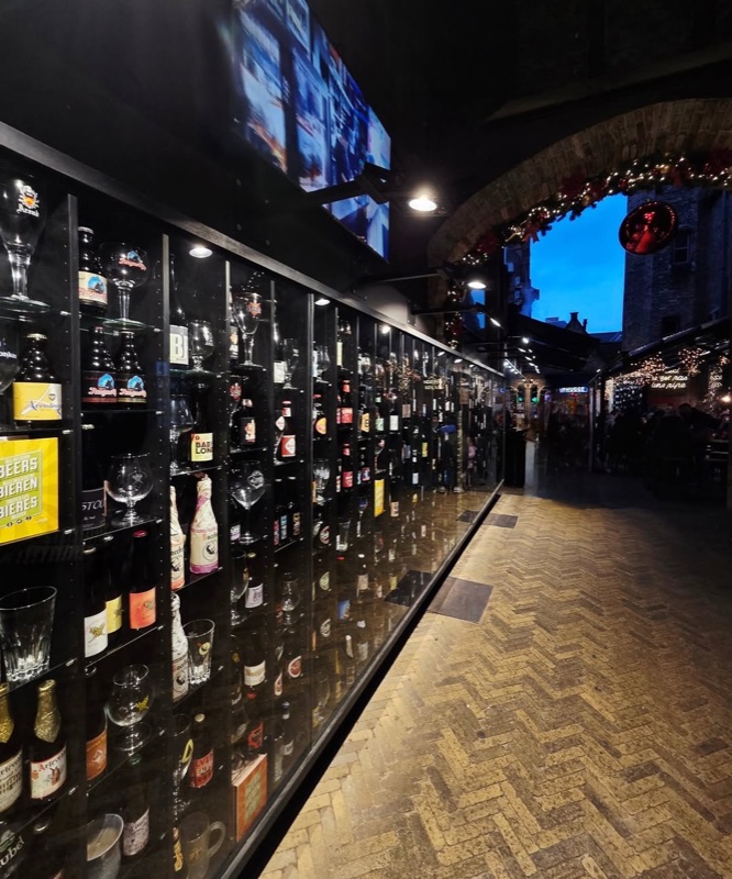 The Beer Capital bar with extensive Belgian beer wall display in Bruges, Belgium