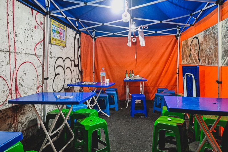 Euljiro Nogari Alley at night with orange tents and plastic chairs