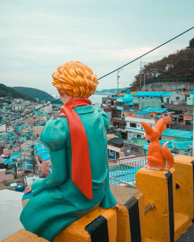 Little Prince and Fox statue overlooking Gamcheon Culture Village rooftops