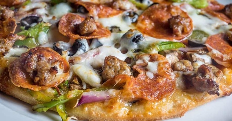 Puccini's Smiling Teeth Pizza & Pasta in Various — Puccini's is a popular local chain known for its consistently good gourmet thin-