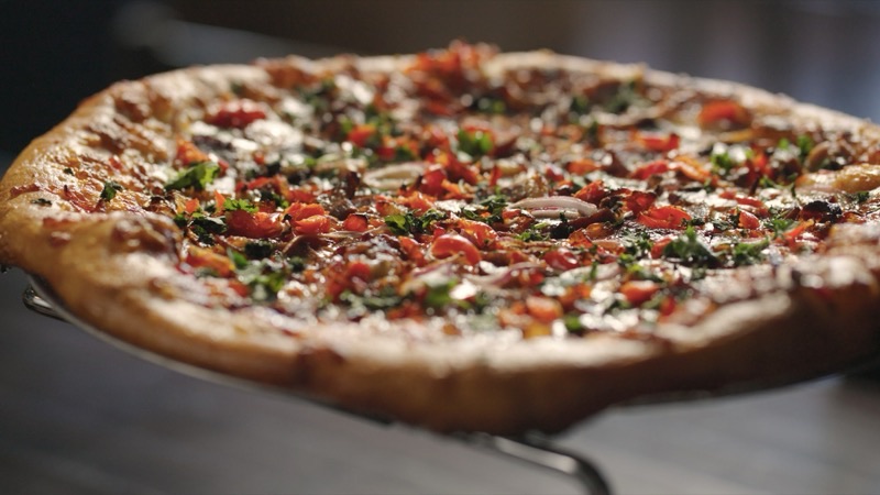 Boombozz Pizza & Watch Bar in Various — Boombozz offers a wide array of gourmet pizzas with creative topping combination
