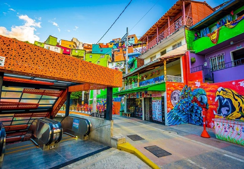Colorful graffiti murals in Comuna 13's main corridor