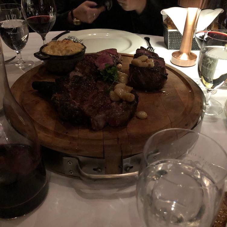 Queue de Cheval Steakhouse in Centre-Ville — A lavish, multi-level steakhouse known for its impressive dry-aging room and an 