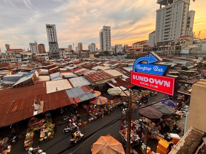 Sundown Social Club rooftop view over Russian Market at golden hour in Phnom Penh