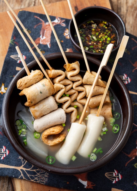 Eomuk fish cake skewers in hot broth at a Korean street stall