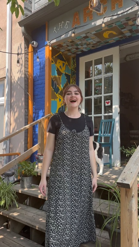 The Arch Café porch with murals and signage in Kensington Market, Toronto