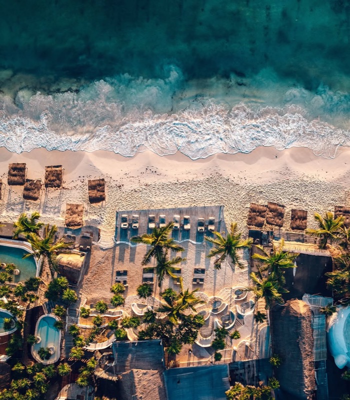 Party at Papaya Playa Project, North Hotel Zone, Tulum — $30–$60 min spend (day) / $20–$40 entry (night)